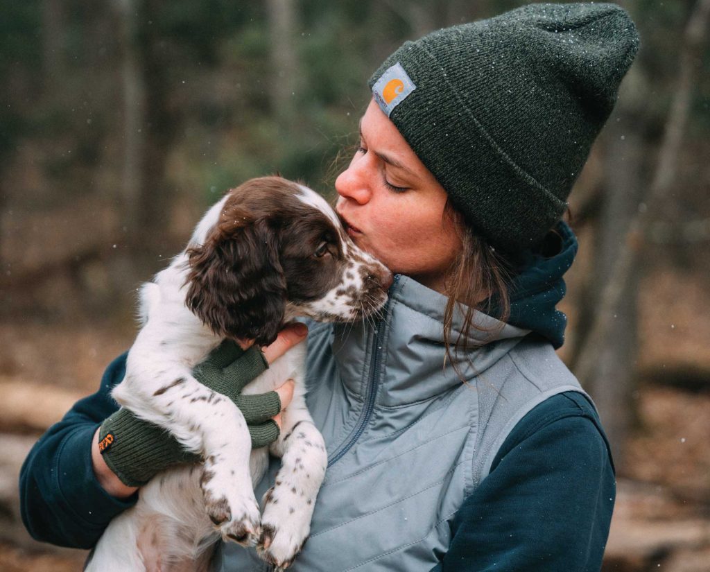 A woman with a bird dog