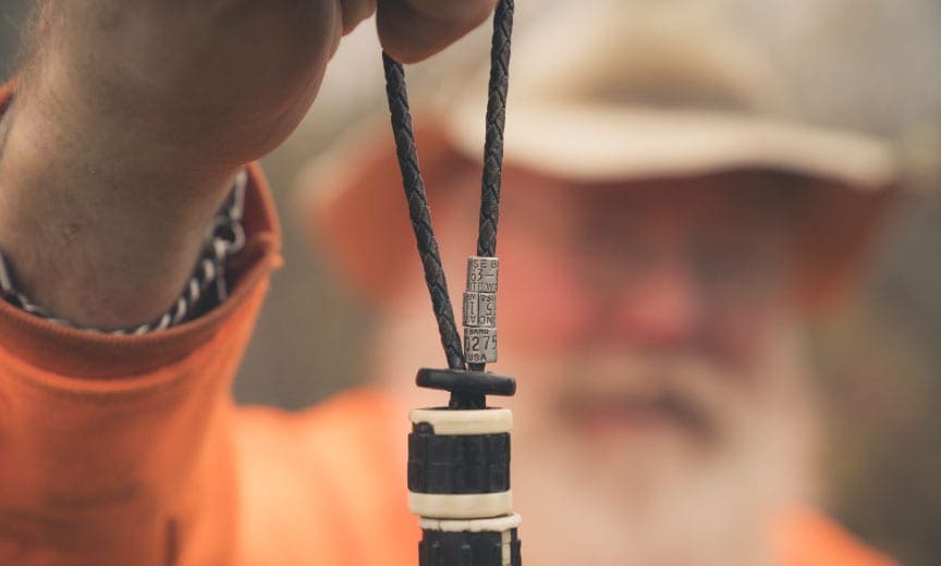 A bird hunter holds up woodcock bands.