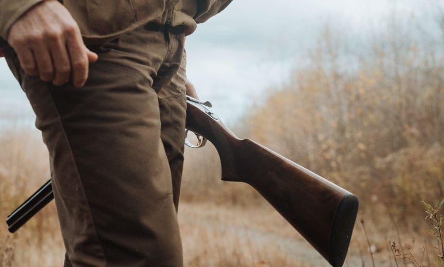 Dr Ben Jones hols a shotgun while grouse hunting.